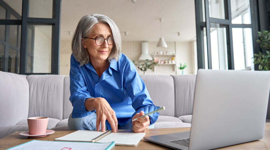 Mature Senior Woman Having Video Call Virtual Class At Home