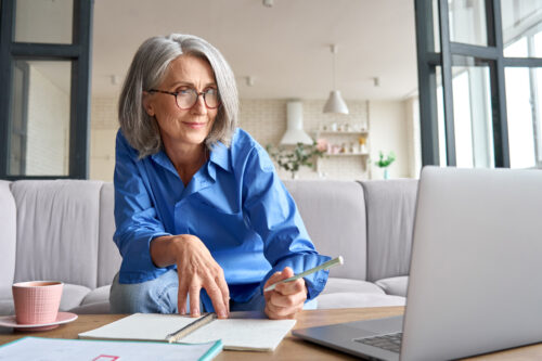 Mature Senior Woman Having Video Call Virtual Class At Home