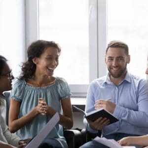 Smiling Multiracial Colleagues Take Part In Motivational Training At Workplace