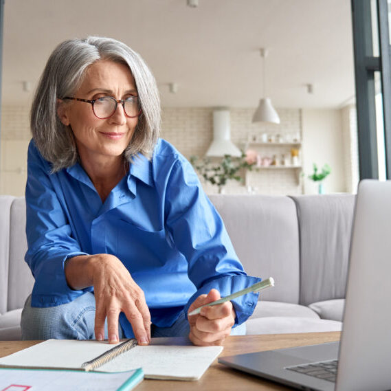 Mature Senior Woman Having Video Call Virtual Class At Home 