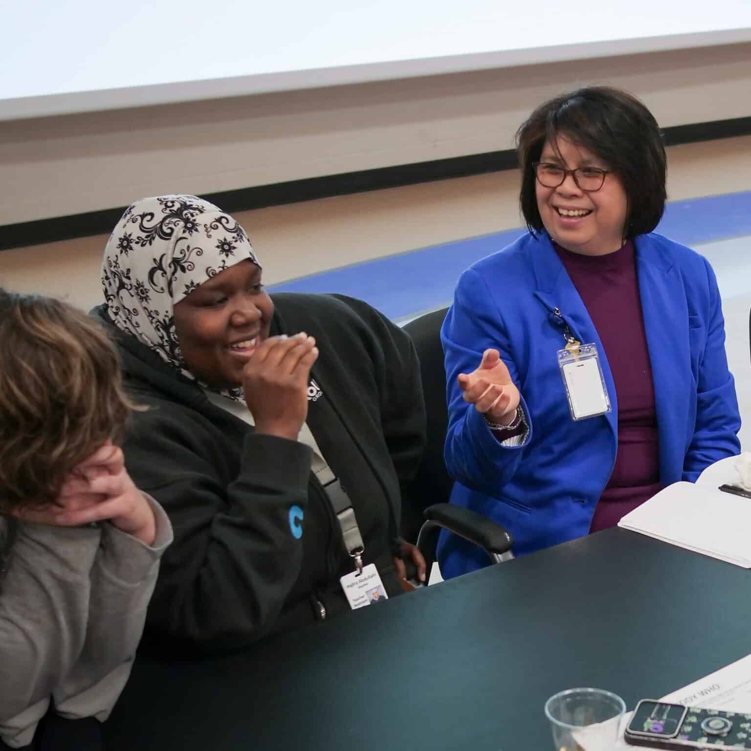 Group of people engaged in discussion at an Acorn Evaluation learning event.